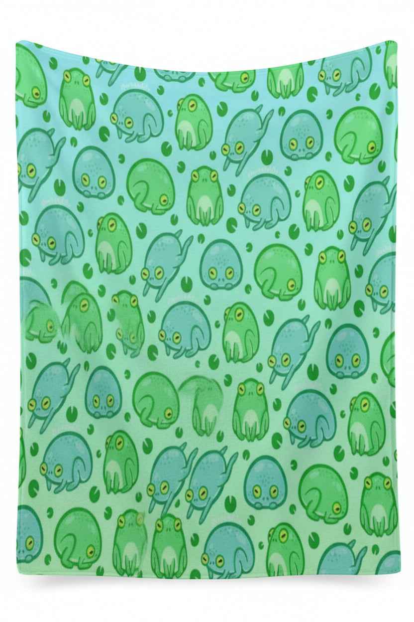 a blanket with a green frog pattern on a light blue background