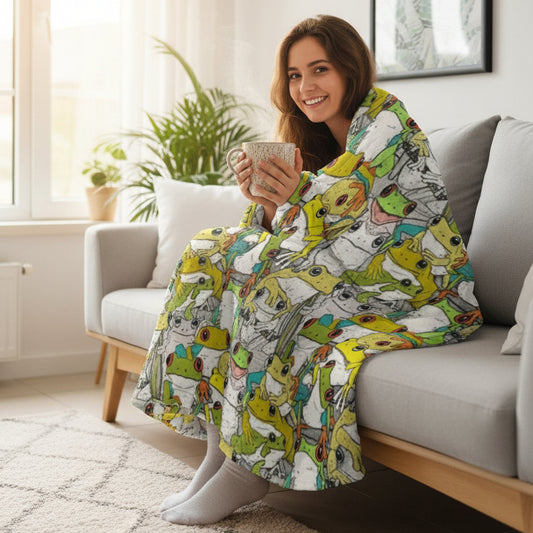 A colorful throw blanket featuring a dense pattern of cartoon frogs in various poses, draped over a light gray sofa in a living room setting.