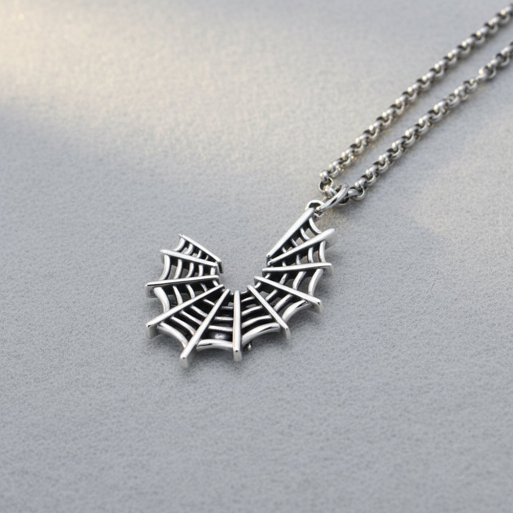 Silver spider web pendant on a chain 