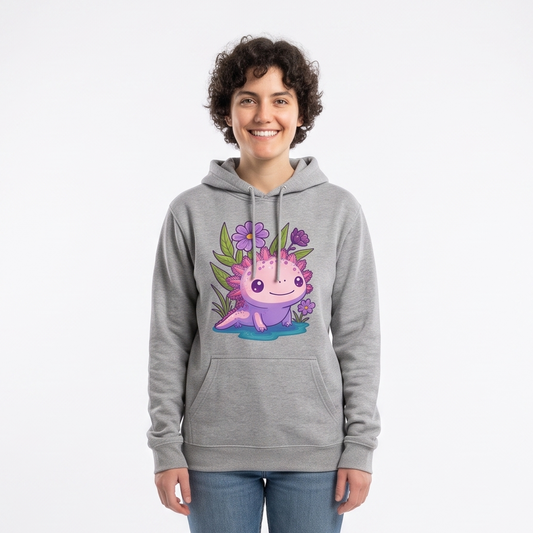 A person standing in a white studio wearing a heather gray pullover hoodie with a colorful cartoon axolotl graphic on the chest, blue jeans, and white sneakers. Softbox lights are visible on both sides of the backdrop.