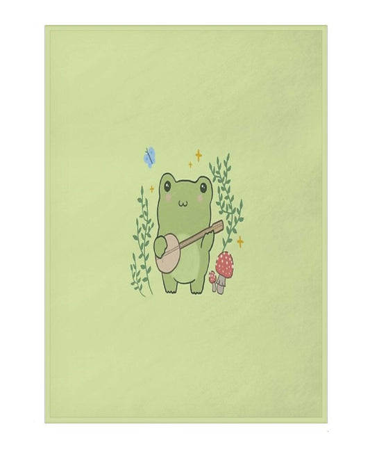 blanket with a cartoon frog playing a banjo