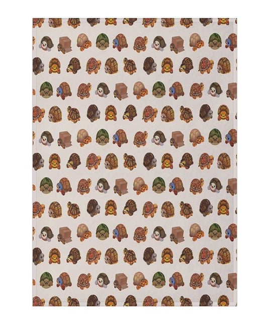 a white blanket featuring a repeating pattern of box turtles 