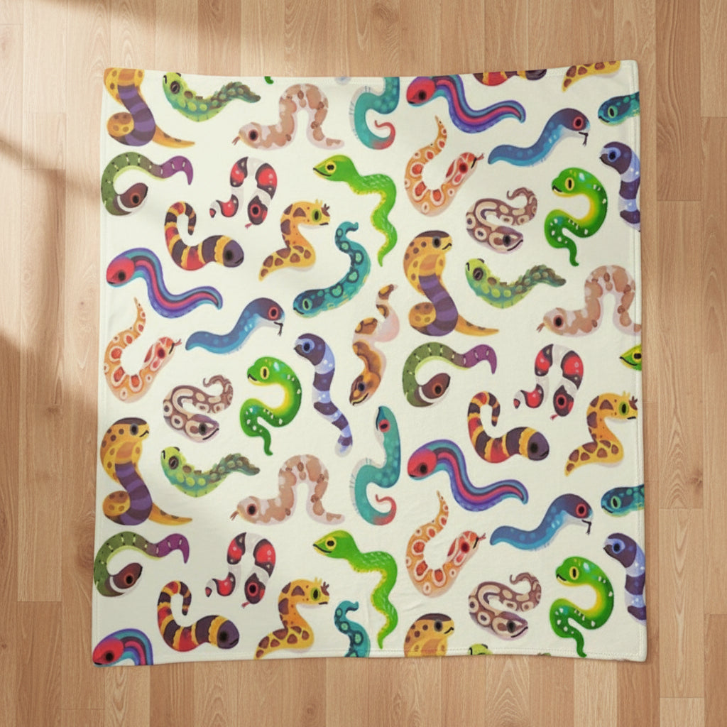 A fleece blanket with a colorful pattern of cartoon snakes on an off-white background