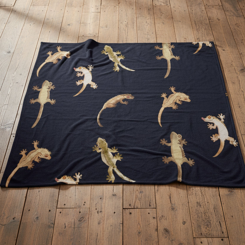 throw featuring a repeating pattern of gecko lizards in beige and light green tones