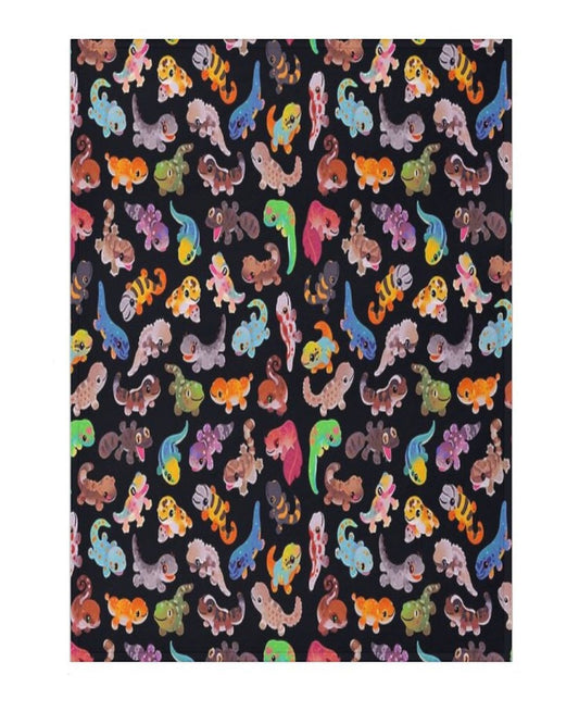 blanket with a colorful gecko pattern on a dark background