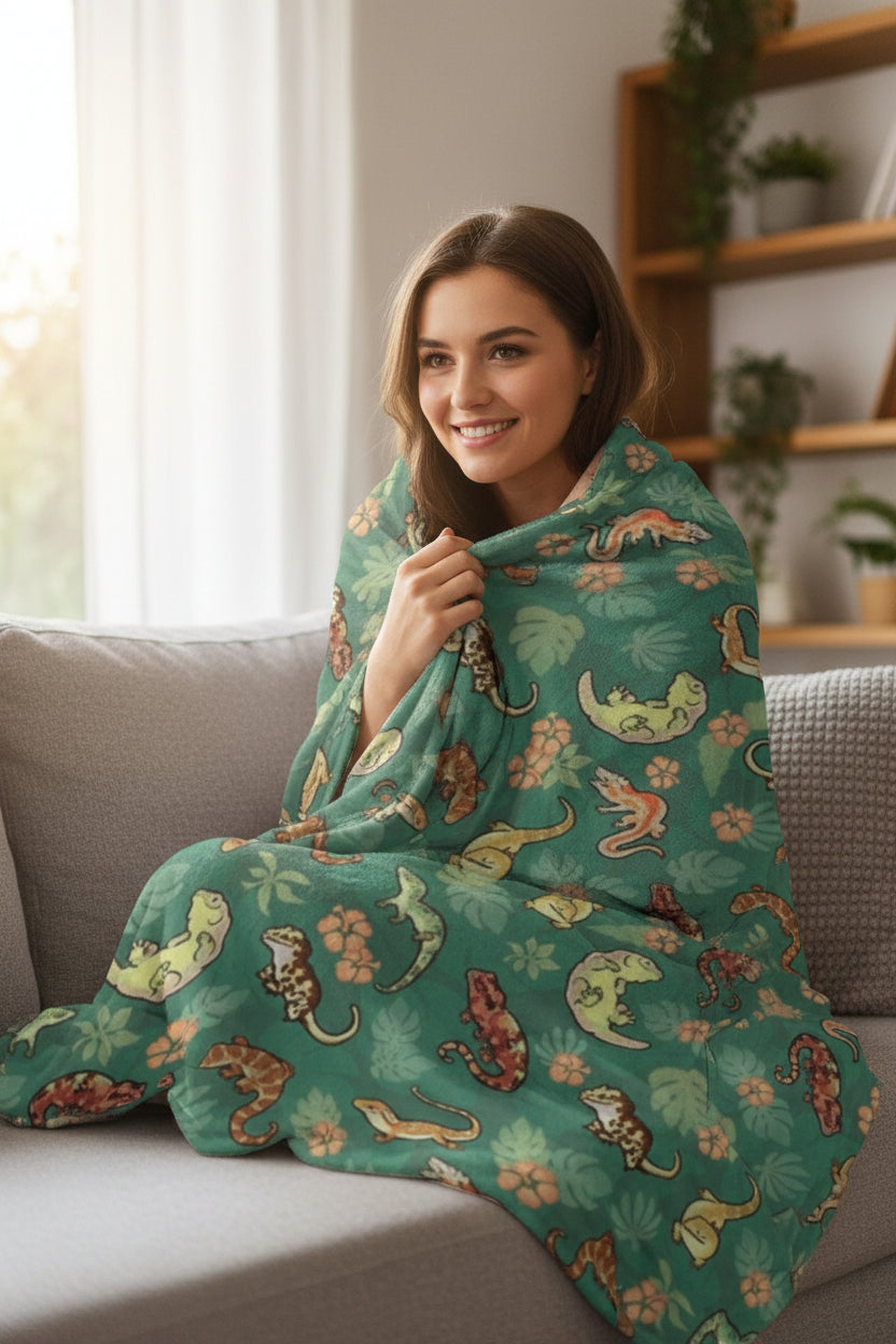 a person wrapped in a blanket with a gecko design