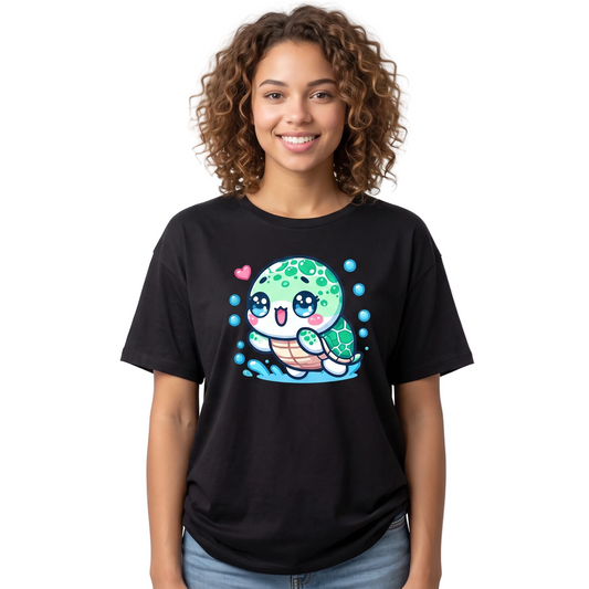 A smiling woman with curly brown hair wearing a black short-sleeve t-shirt with a colorful cartoon sea turtle graphic on the front, paired with blue jeans, against a plain white background.