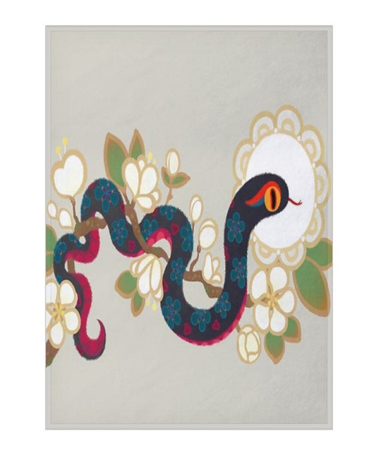 a blanket showing a stylized snake winding through white flowers on a light gray background