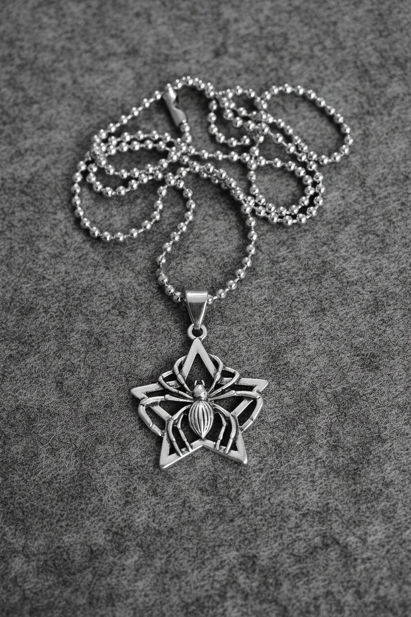 Silver necklace with a star-shaped pendant on a light gray background